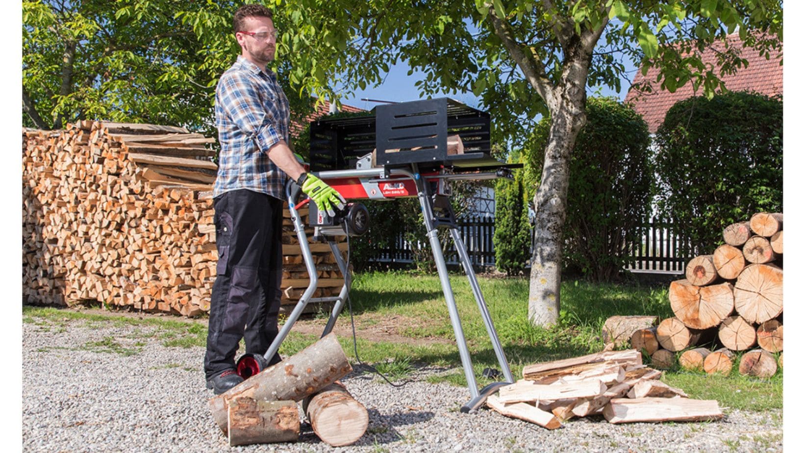 a man cutting logs using a horizontal log splitter