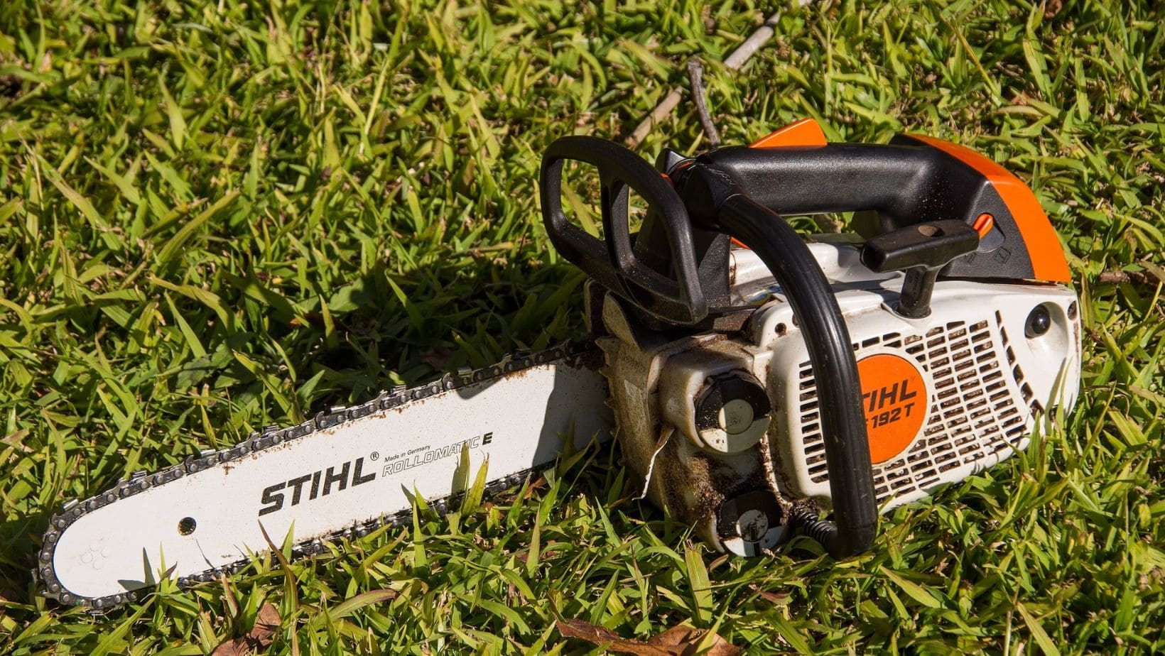 a STIHL chainsaw lying on the grass