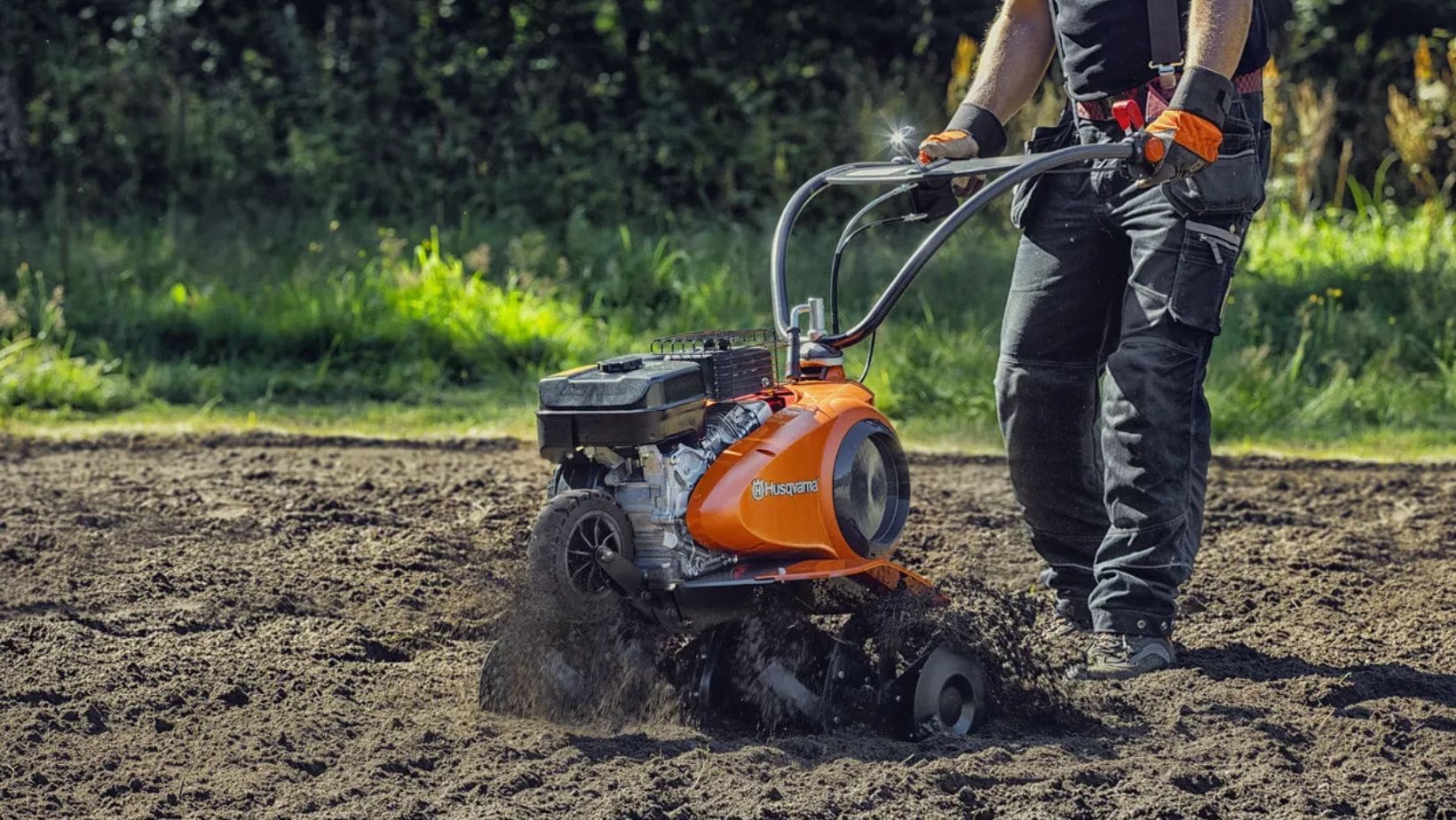 a man using a Husqvarna cultivator to till soil